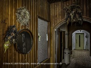 Langer mit Holz vertäfelter Gang eines verlassenen Hotels.