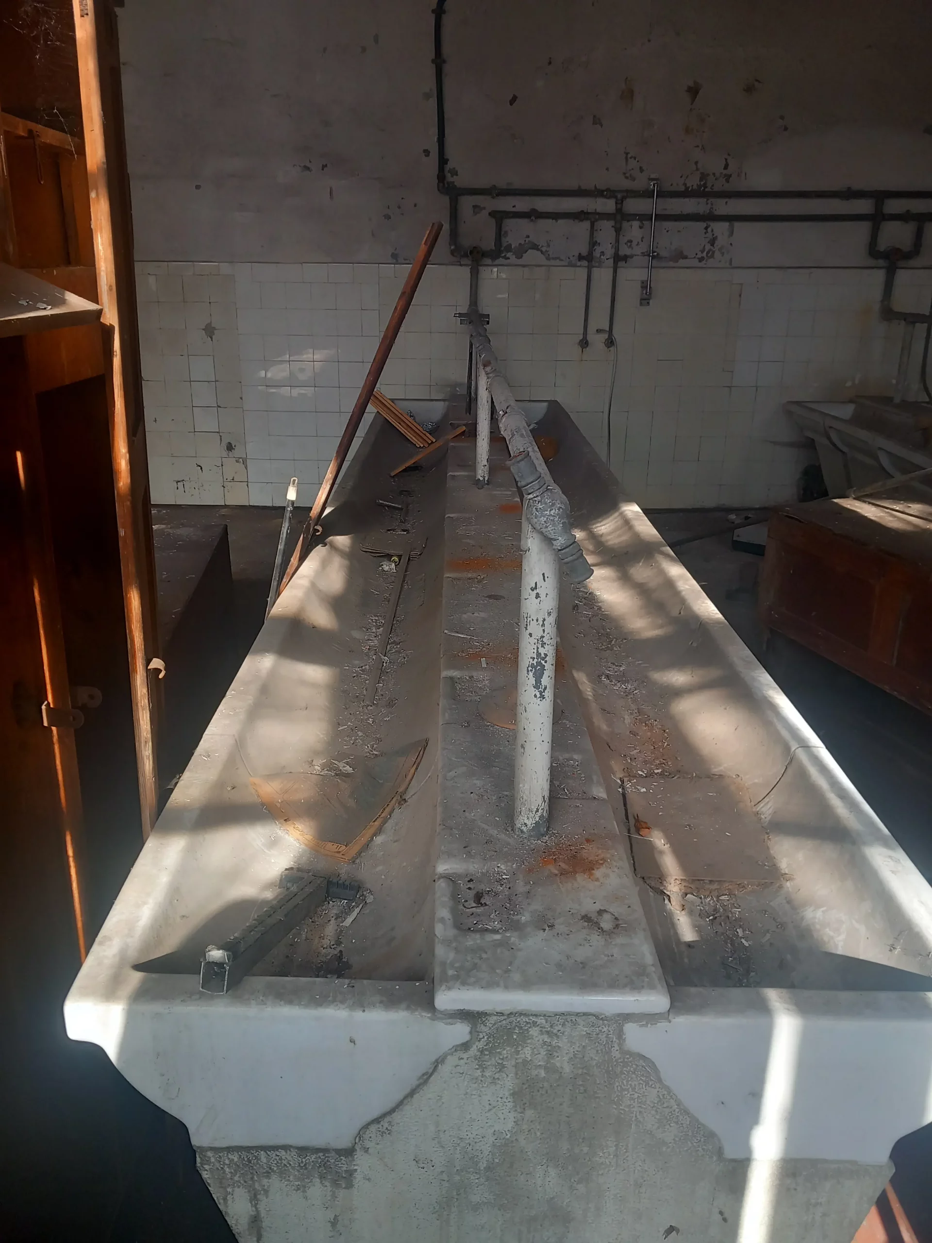 Gemeinschaftswaschbecken in der Umkleide der verwaisten Fabrikanlage.