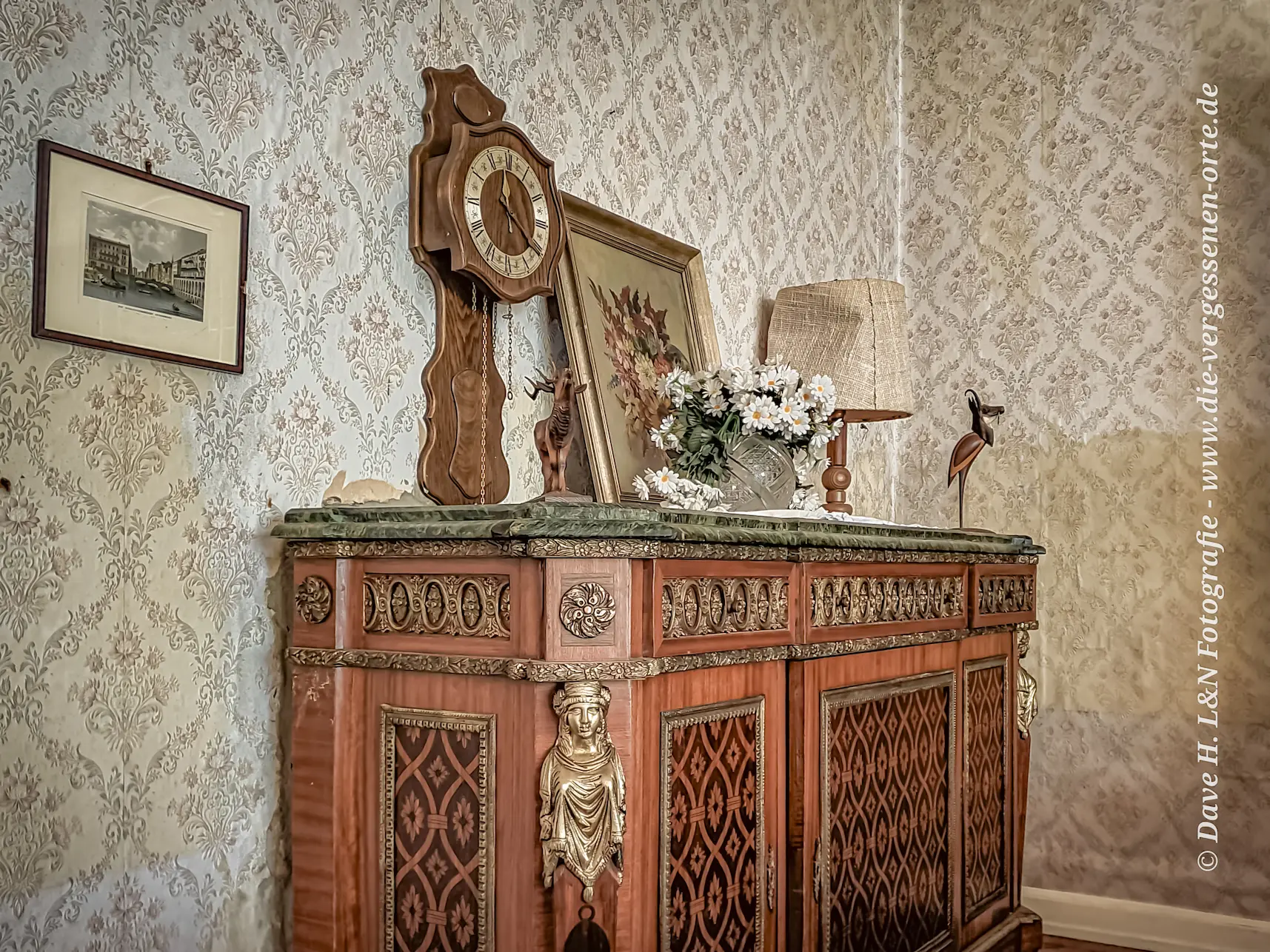 Holzschrank mit Verzierungen und Marmorplatte im verlassenen Schloss.