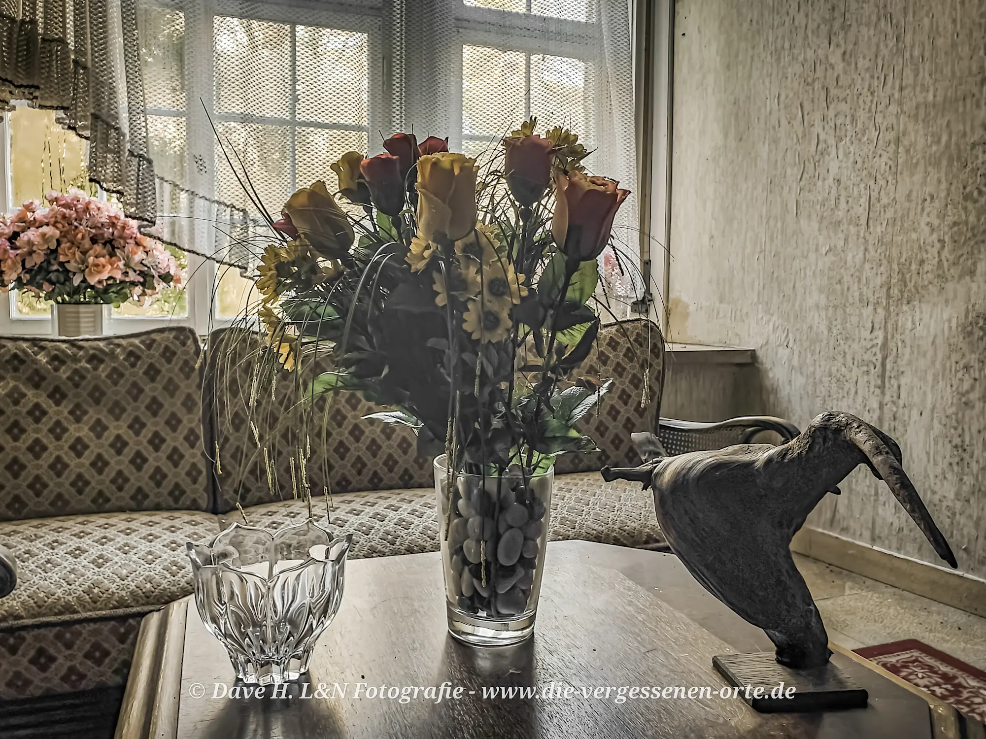 Blumenstrauß auf Tisch in der Sitzecke des verlassenen Schlosses.